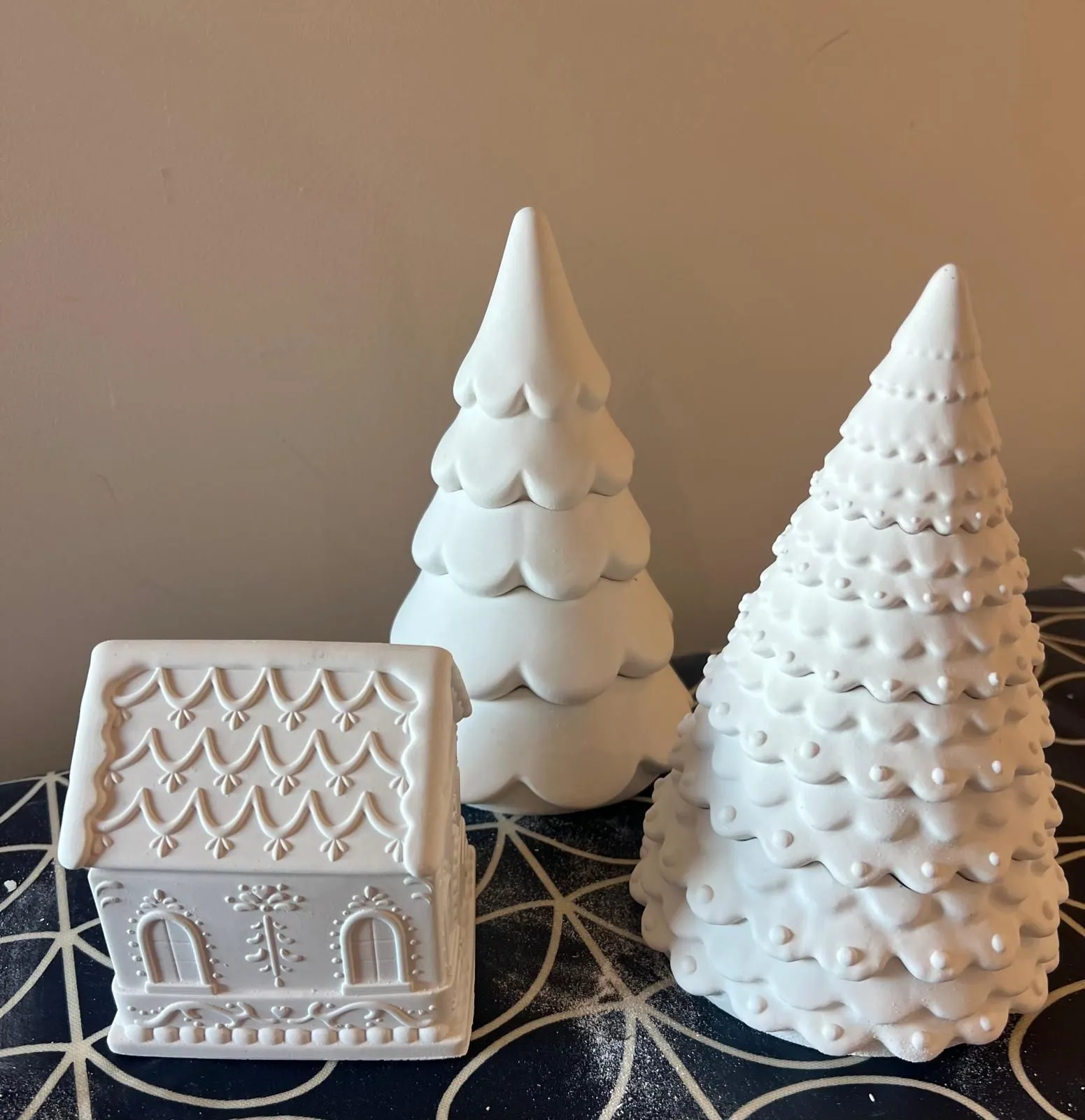 Unfinished handmade ceramic holiday houses and trees