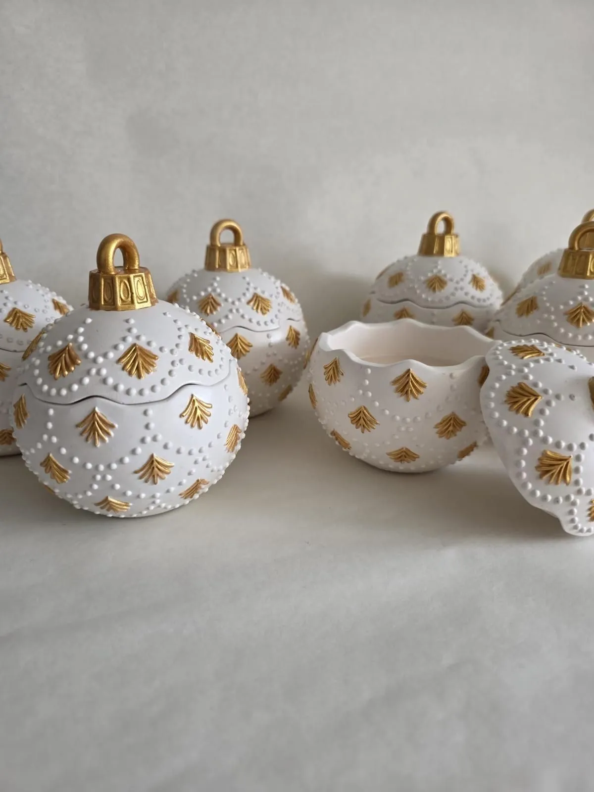White pearl-detailed ornament candle vessels with gold accents