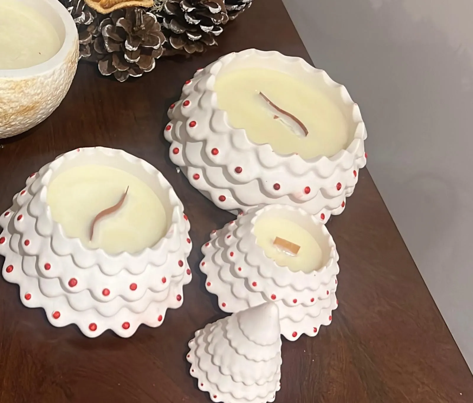 Handmade white tree candles with festive red details